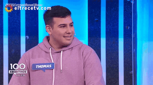 a man wearing a purple hoodie with the name thomas on it