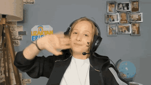 a boy wearing headphones and a sign that says izaktan eric on it
