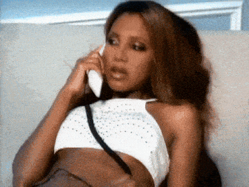 a woman in a crop top is talking on a phone