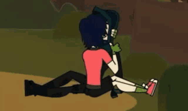 a couple of cartoon characters are sitting next to each other on the ground .