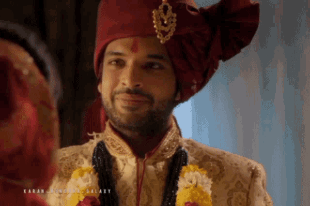 a man wearing a red turban looks at a woman in a galaxy advertisement