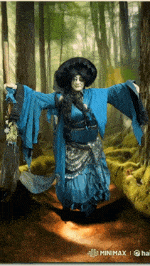 a witch in a blue dress is holding a broom