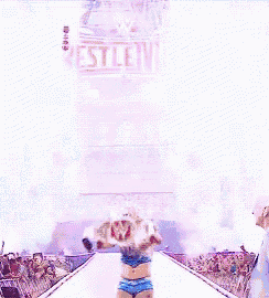 a wrestler is walking down a ramp in front of a wrestlemania sign