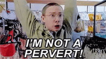 a boy is standing in a store with his arms in the air and says i 'm not a pervert !