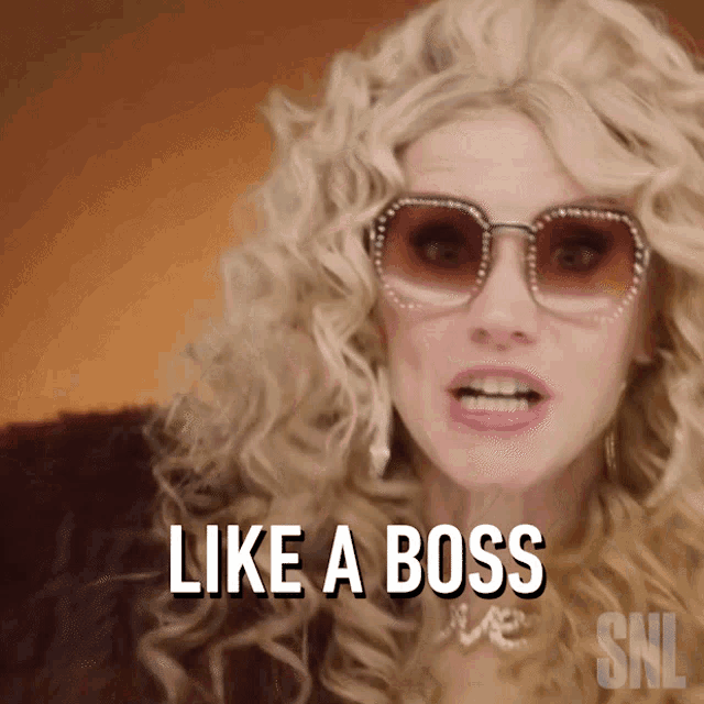a woman wearing sunglasses and a fur coat says " like a boss "