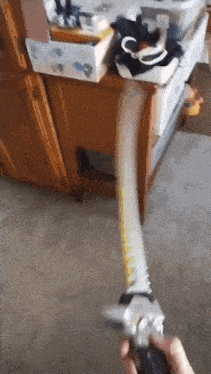 a person is holding a tape measure in their hand