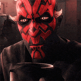 darth maul is holding a cup of coffee in his hand