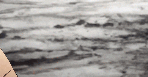a black and white photo of a person holding a pencil