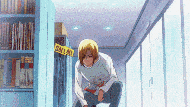 a man is squatting down in front of a sign that says sell all