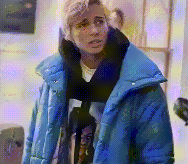 a man is wearing a blue jacket and scarf .