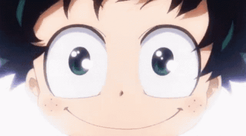 a close up of a person 's face with big eyes and a smile on their face .