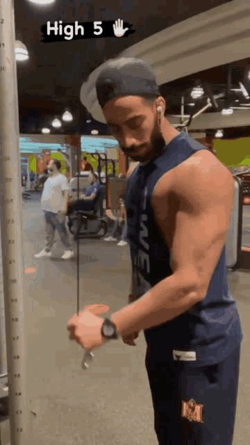 a man wearing a tank top that says " high 5 " on it