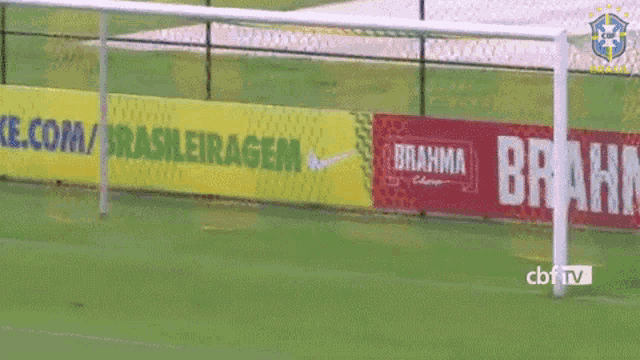 a soccer goal is surrounded by advertisements for brahma and nike
