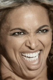 a close up of a woman making a face with her mouth open