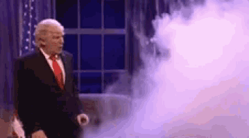 a man in a suit and tie is standing in front of a window with smoke coming out of his mouth .