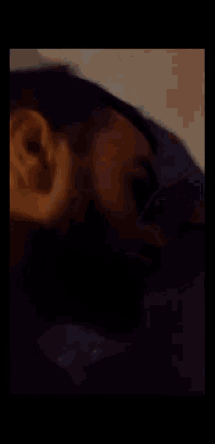 a blurry picture of a person laying on a couch