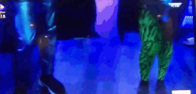 a blurred image of a person 's feet on a tv screen that says ' big brother ' on it