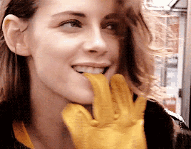 a woman with a yellow glove on her hand