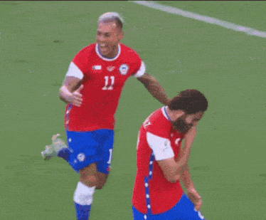a soccer player with the number 11 on his jersey is running with another player