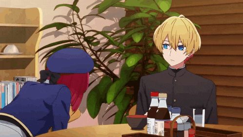 a man and a woman sit at a table with bottles of sauce on it