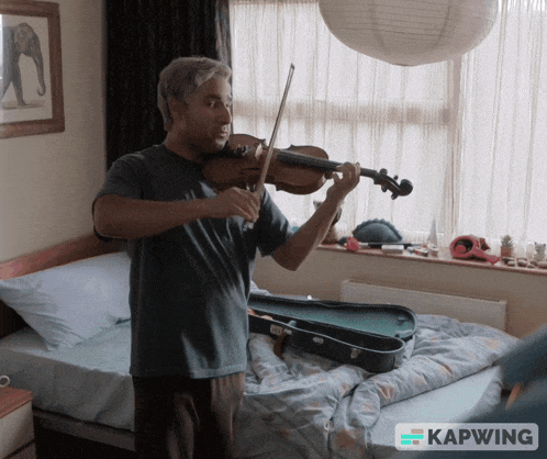 a man playing a violin in a bedroom with a kapwing logo on the bottom