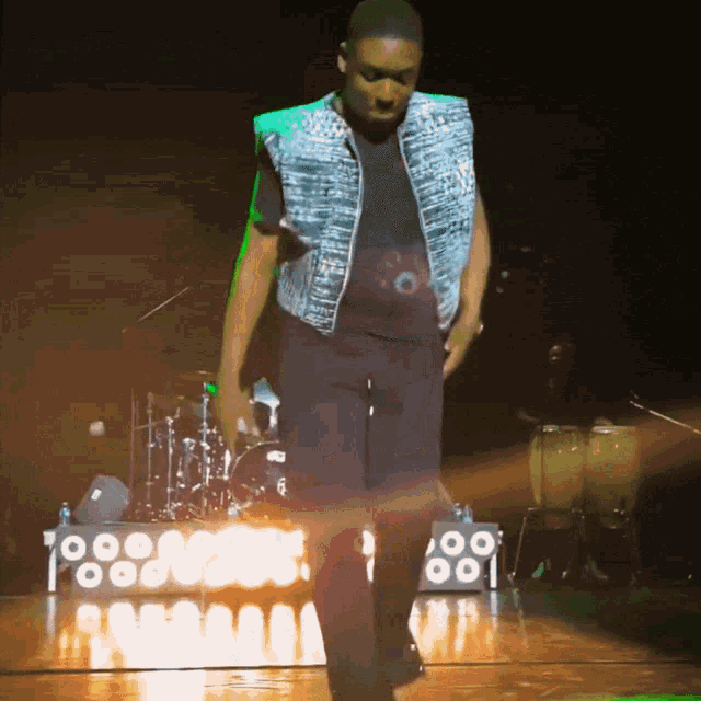 a man is dancing on a stage with a sign that says ' 88 ' on it