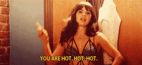 a woman in lingerie is standing in front of a door and saying you are hot hot hot .
