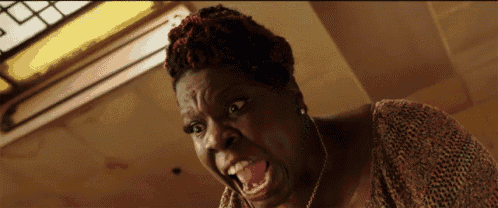 a close up of a woman making a funny face with her mouth open