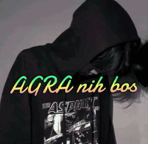 a person wearing a black hoodie that says " agra nih bos "
