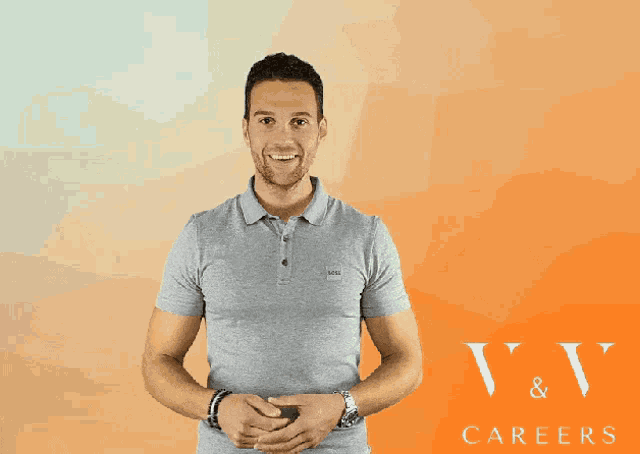 a man in a grey polo shirt is smiling in front of an orange background that says v & v careers
