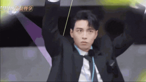 a man in a suit and tie is holding a rope over his head ..