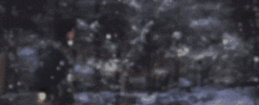a blurry picture of a snowy forest at night