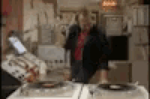 a blurry picture of a man playing a record on a turntable