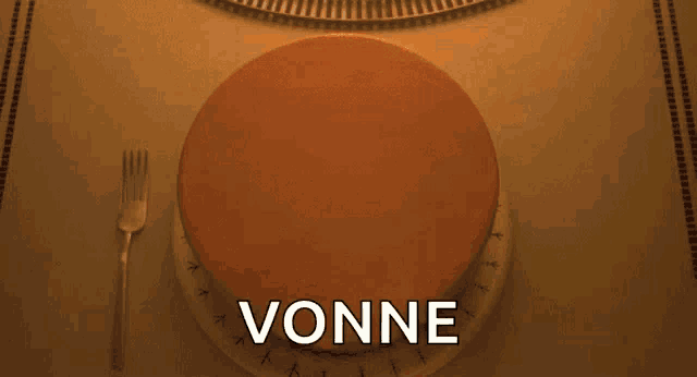 a birthday cake with candles on it is sitting on a table with the word vonne written on it .