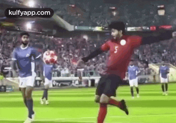 a group of soccer players are playing a game of soccer on a soccer field .