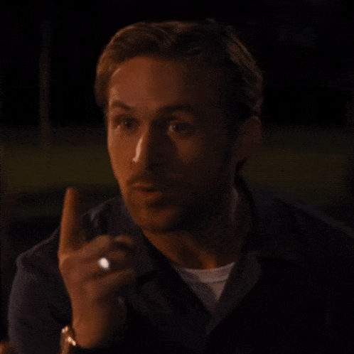 a man with a ring on his finger points upwards