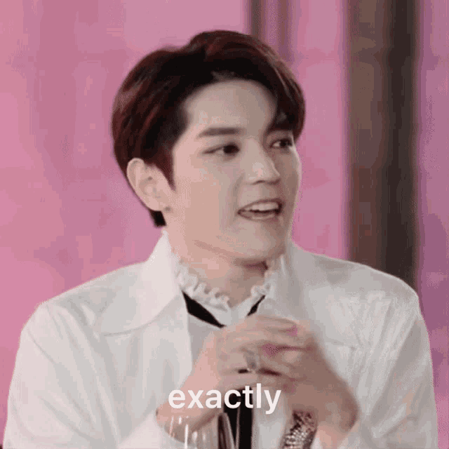 a man wearing a white shirt and tie is holding a glass of wine and says exactly