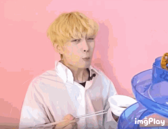 a boy is playing with a toy that says ' imgplay ' on the bottom