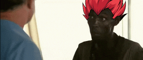 a man with a red haired cartoon character on his head talks to another man