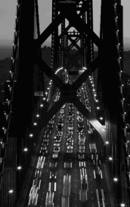 a black and white photo of a bridge with the words inconstancy on the bottom right