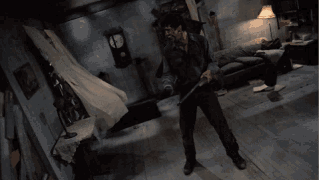 a man is holding a sword in a dark room with a clock on the wall