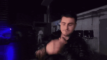 a man with a ring on his finger is covering his face with his hands