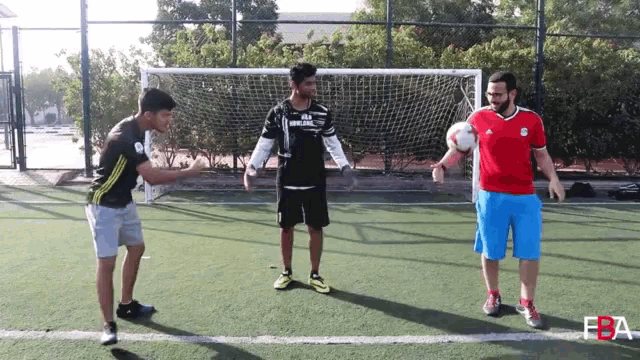 a man wearing a jersey that says fly emirates is standing on a soccer field
