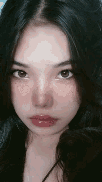 a close up of a woman 's face with freckles on her face