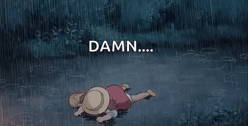 a little girl is laying on the ground in the rain with the words `` damn '' above her .