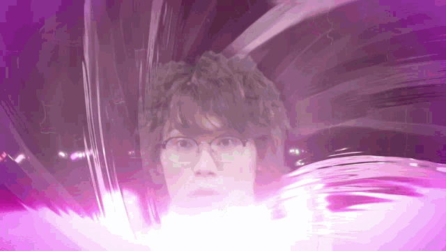 a man wearing glasses is surrounded by purple light