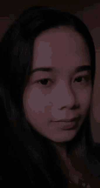 a close up of a woman 's face smiling with her mouth open .