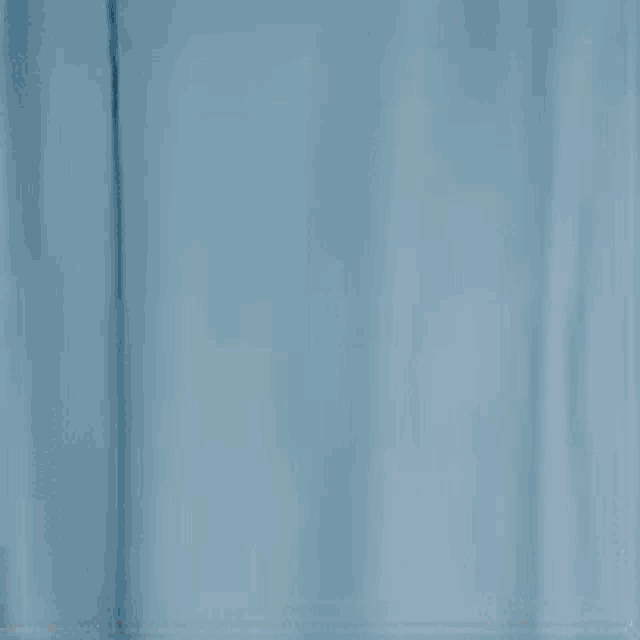 a man and a woman are standing next to each other in a room .