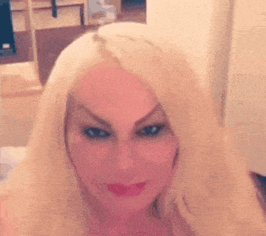 a woman with blonde hair is taking a selfie