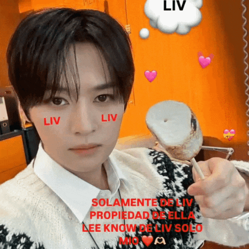 a man with the word liv on his face is holding a marshmallow